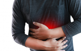 man wrapping his arm around his stomach