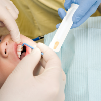 child receiving fluoride treatment