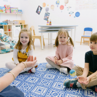 Three children and teacher in classroom