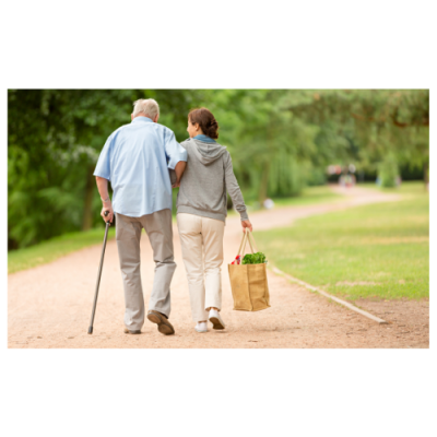 Elderly man walking with caregiver